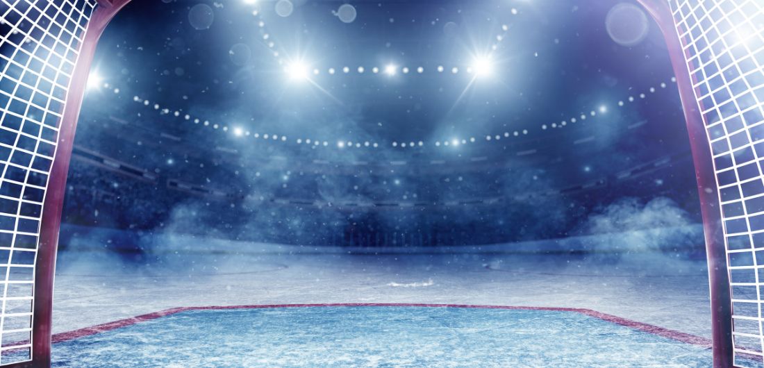 Jääkiekkomaali ja peliareena valaistuna.